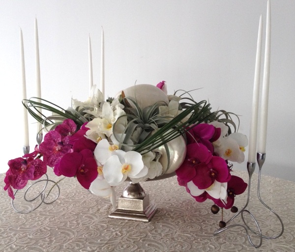 Classic silver elements and elongated taper candles contrasted the modern-esque arrangement beautifully