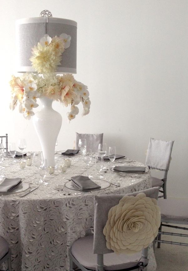 The chair covers helped tie the linen shade and oversized flowers in beautifully 